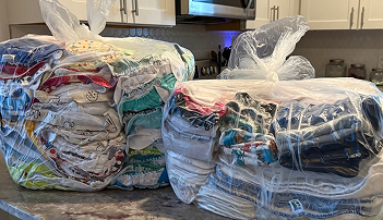 Neatly organized closet, with clothes hung and folded